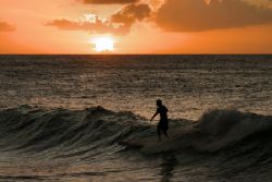 Surfing at sunset @ Turtle Bay Oahu by Glenn Poulain 